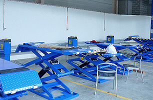 Motorcycle scissor lifts installed in multi service bay workshop