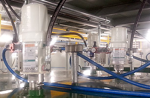 Suspended ceiling workshop pit showing lubrication pumps from main tanks to hose reels