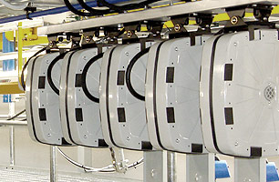 Encased lubrication hose reels mounted to roof of suspended ceiling workshop pit