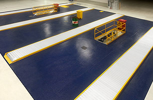 Suspended ceiling workshop pit with 3 pit bays showing safety covers in closed postition from above ground